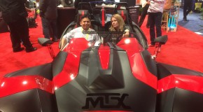 Me and +Amanda Blain sitting in a red spaceship-looking car fit for +AMD RedTeam…